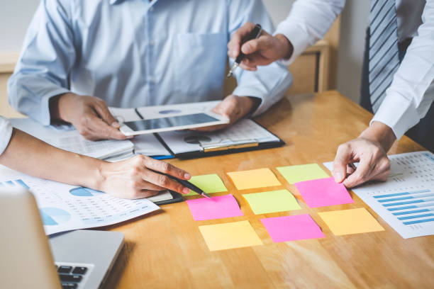 istock Co working conference, Business team colleagues discussing working analysis with financial data and marketing growth report graph in team, Meeting Talking Brainstorming Communication Concept 1081061738