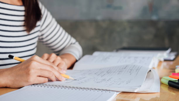 istock Young student sitting at desk in home studying and reading, doing homework and lesson practice preparing exam to entrance, education concept 1081061878