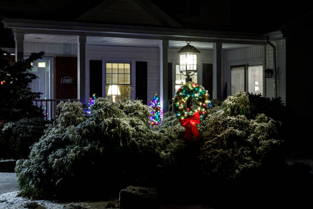 istock Illuminated Outdoor Christmas Trees and Decorated Wreath 1081063016