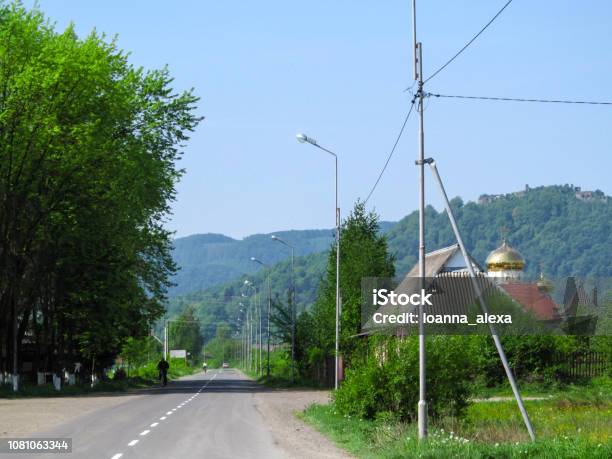 Summer Landscape Of Ivan Chendey Street In Khust With The Ruins Of An Ancient Fortress On A Hill Stock Photo - Download Image Now