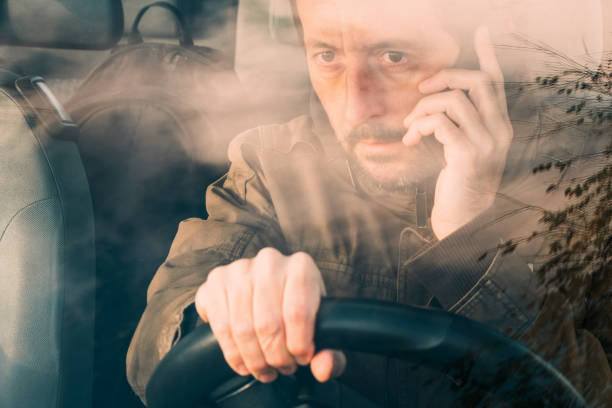 istock Front view of man driving car and talking 1081071860