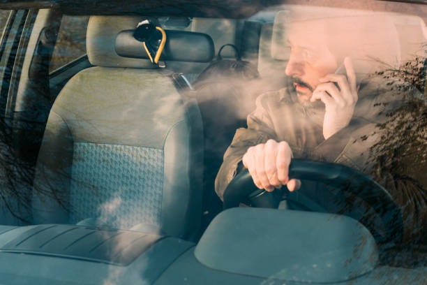 istock Front view of man driving car and talking 1081071916