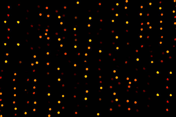 Defocused image of outdoor Christmas decoration against a black winter night.
