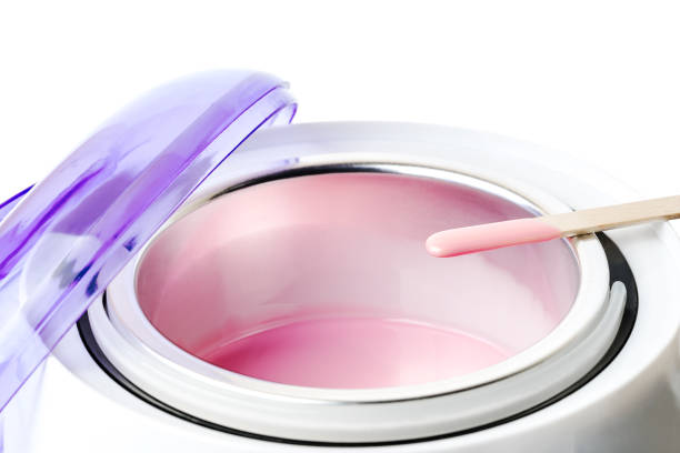 istock Wax heater with hot pink wax and a spatula 1081076938