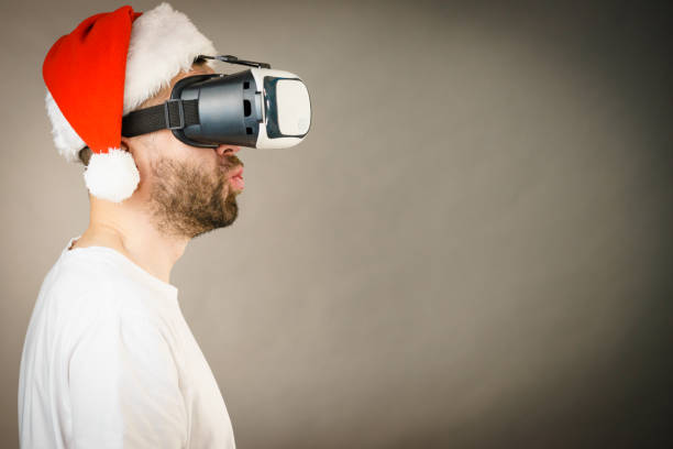 istock Man in virtual reality goggles and santa hat 1081077200