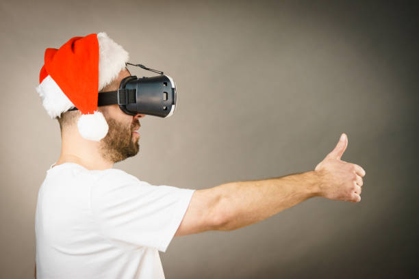 istock Man in virtual reality goggles and santa hat 1081078652