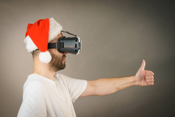 istock Man in virtual reality goggles and santa hat 1081079010