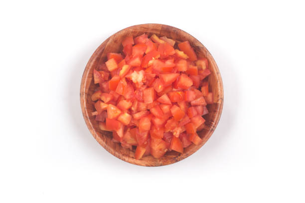 Chopped Tomatoes in a wooden  bowl isolated on white background Top view