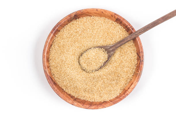 istock Demerara sugar in a wooden  bowl. Top view 1081087402