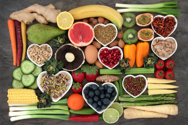 Super Food for a Healthy Diet Super food concept for a healthy diet with fruit and vegetables, dairy, spices, nuts, legumes, cereals and grains, high in antioxidants, anthocyanins, dietary fibre and vitamins. vitamin stock pictures, royalty-free photos & images