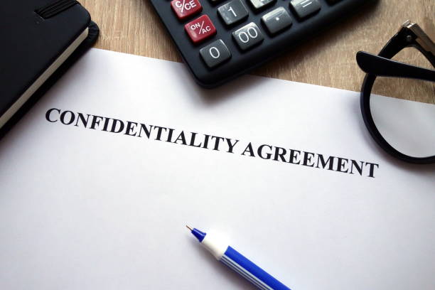 istock Confidentiality agreement, calculator, pen and glasses 1081090814