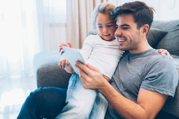 istock Father and daughter looking at digital tablet 1081095204