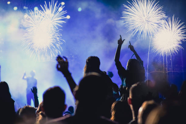 istock crowd watching fireworks - New Year celebrations- abstract holiday background 1081099206