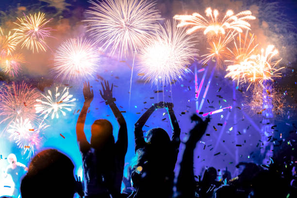 istock crowd watching fireworks - New Year celebrations- abstract holiday background 1081099240