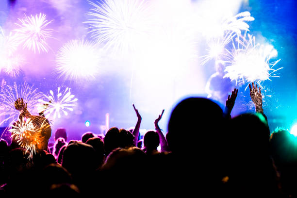 istock crowd watching fireworks - New Year celebrations- abstract holiday background 1081099248