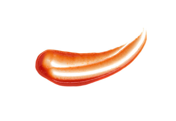 Smeared puddle of tomato dressing or ketchup spot
