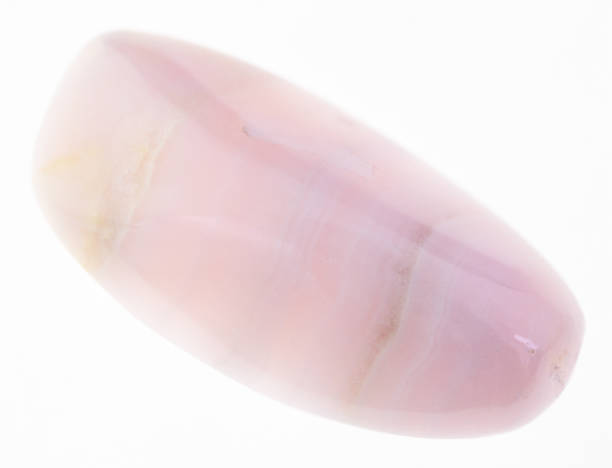 istock tumbled mangano calcite gem stone on white 1081110176