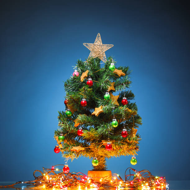 istock Christmas tree with festive lights, blue background 1081120704