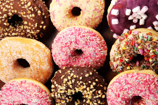 istock assorted donuts with chocolate frosted, pink glazed and sprinkles donuts 1081123374