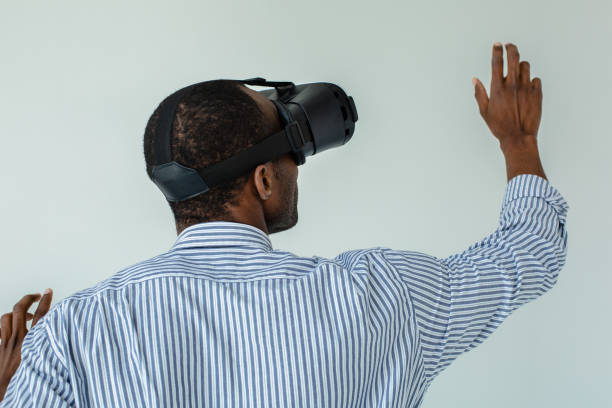 istock Rear view of a nice afro american man using VR glasses 1081128882
