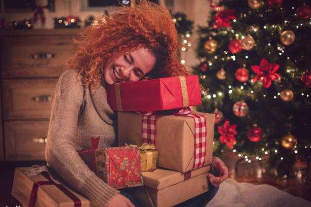 istock Young Beautiful Girl With Present in a Cozy Christmas Atmosphere 1081129902