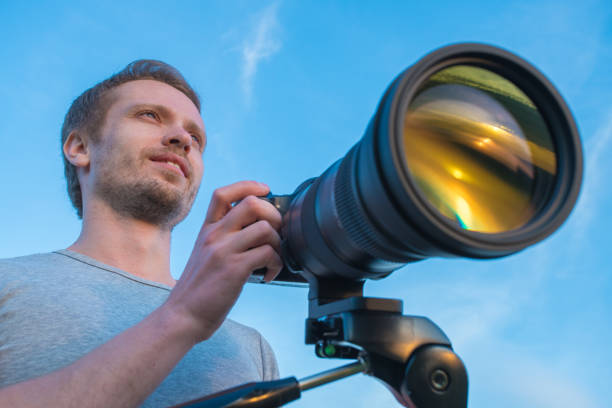 istock The man work with the camera on the blue sky background 1081136410