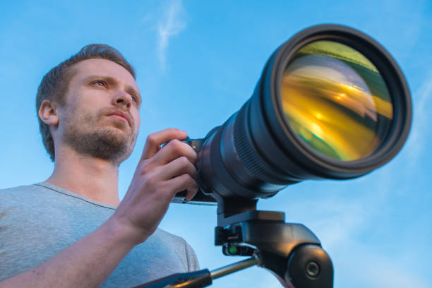 istock The man work with the camera on the blue sky background 1081136454