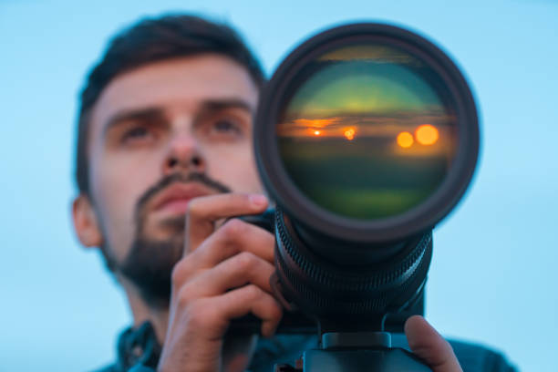 istock The man work camera lens on the background of the sky 1081136624