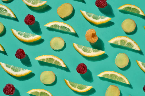 istock Fresh organic pattern from pieces of lemon and raspberry for healthy tea on a blue background. Food background. Flat lay 1081138434
