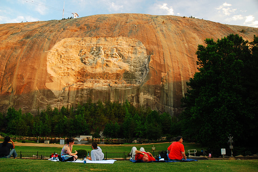 Stone Mountain, GA, USA June 16, 2008 People have a picnic dinner under a large granite carving of Confederate Generals in Stone Mountain, Georgia