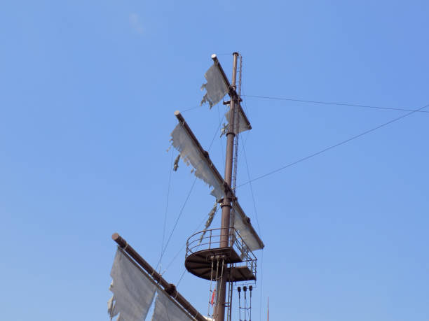 istock Crow's nest and torn sails on the old pirate sailboat 1081152320