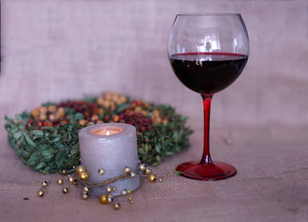 wine glass with candle and Christmas decoration