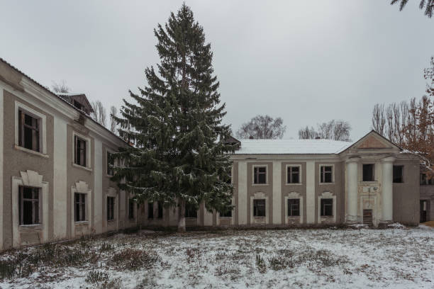 istock Ruined abandoned old mansion facade in winter 1081159378