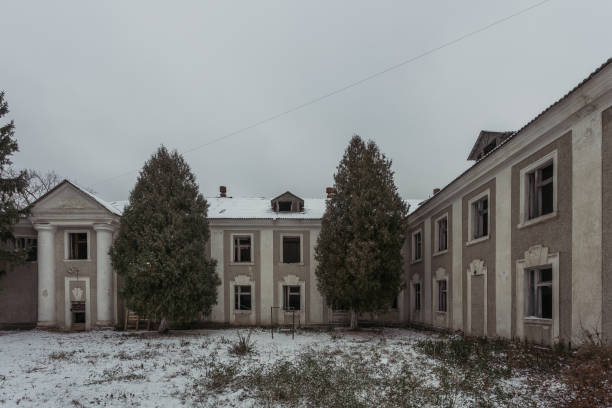 istock Ruined abandoned old mansion facade in winter 1081159400