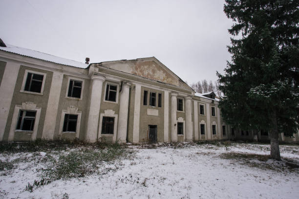 istock Ruined abandoned old mansion facade in winter 1081159448