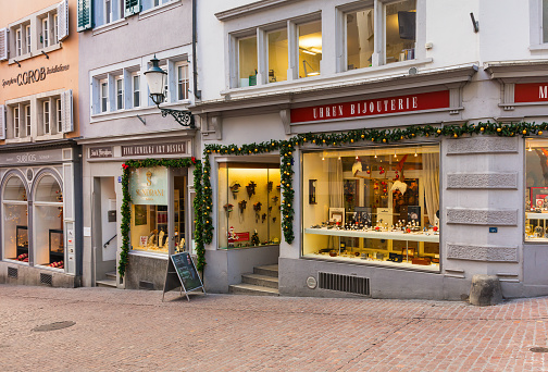 Traditional store front with classical decoration. One woman passing by. Hot Soup sign