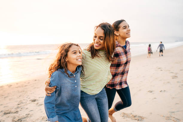 Mother with two daughters on the beach