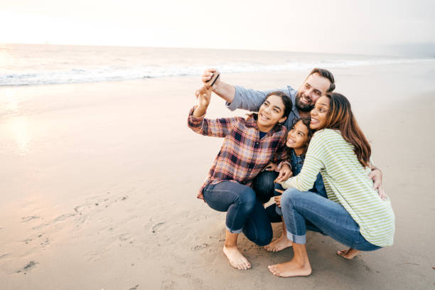 istock Family taking selfie on the beach 1081175646