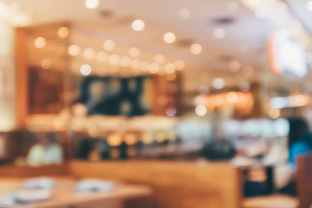 istock Cafe Restaurant interior with customer and wood table blur abstract background with bokeh light 1081176522