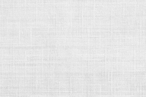 Photo of White jute hessian sackcloth canvas sack cloth woven texture pattern background in white light grey color
