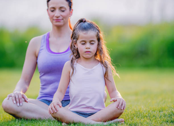 istock Mother and daughter yoga 1081179432