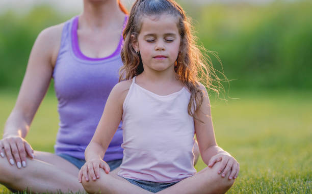 istock Girl and mom doing yoga 1081179438