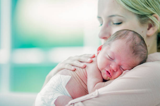 istock Newborn baby sleeping on mom's shoulder 1081182324