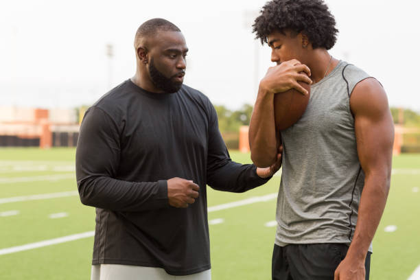istock American Football coach training a young athlete. 1081184838
