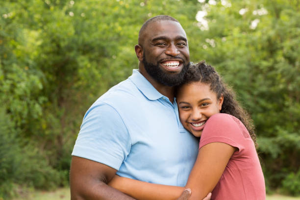 Father hugging his daughter Portrait of a loving father and his daughter. father and daughter stock pictures, royalty-free photos & images