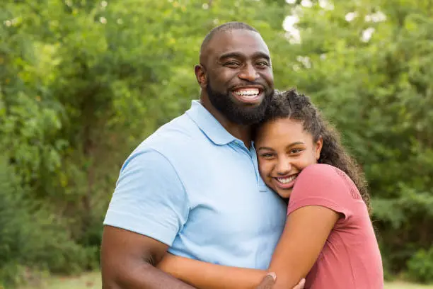 Photo of Father hugging his daughter