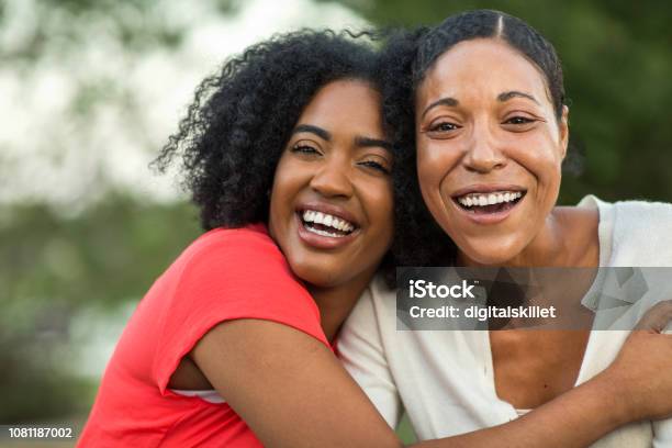African American Mother Hugging Her Adult Daughter Stock Photo - Download Image Now