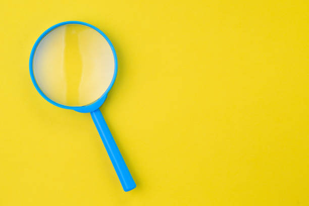 istock Blue magnifying glass, magnifier on yellow background with copy space using as search, transparent, science discovery or SEO concept 1081190498