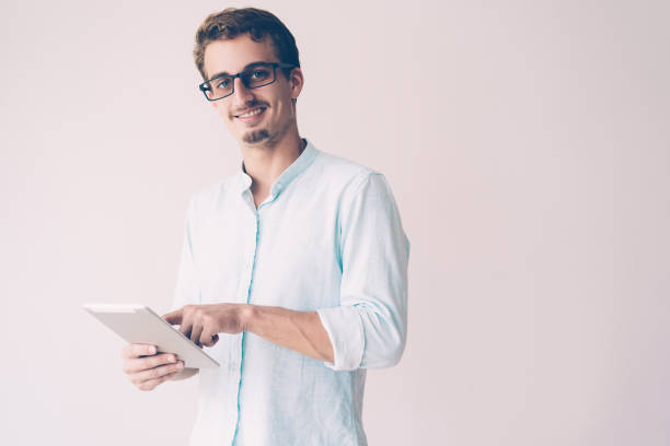 istock Cheerful excited young businessman touching tablet screen 1081201588