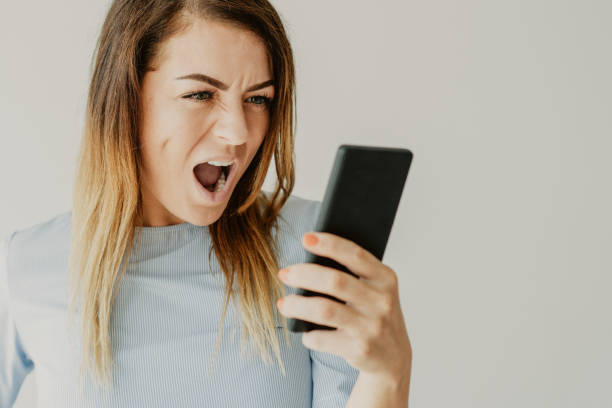 istock Angry woman shouting at smartphone 1081201690
